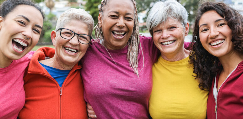 Happy multi generational women having fun together - Multiracial friends laughing on camera after sport workout outdoor - Main focus on african female face